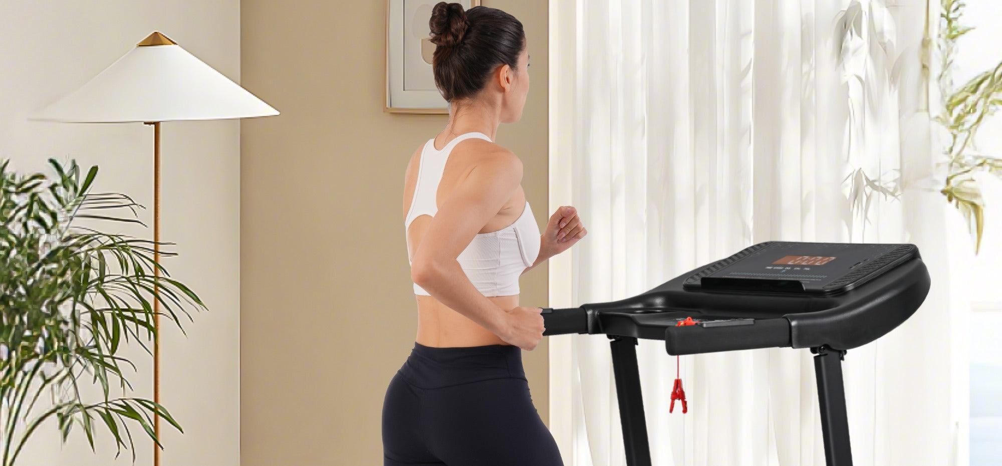 Woman working out on the Rolenva foldable treadmill at home